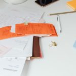 Close-up of a tidy desk with receipts, documents, and office stationery for business organization.