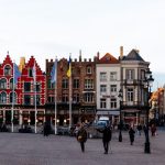 Colorful historic buildings in Bruges' Markt Square, a UNESCO World Heritage site.