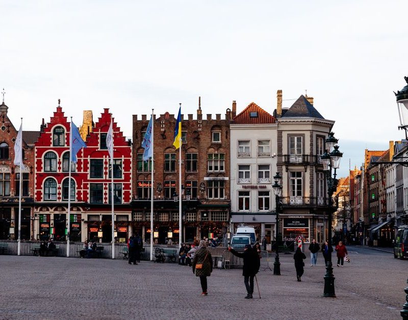 Colorful historic buildings in Bruges' Markt Square, a UNESCO World Heritage site.