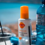 white and orange plastic bottle on blue table