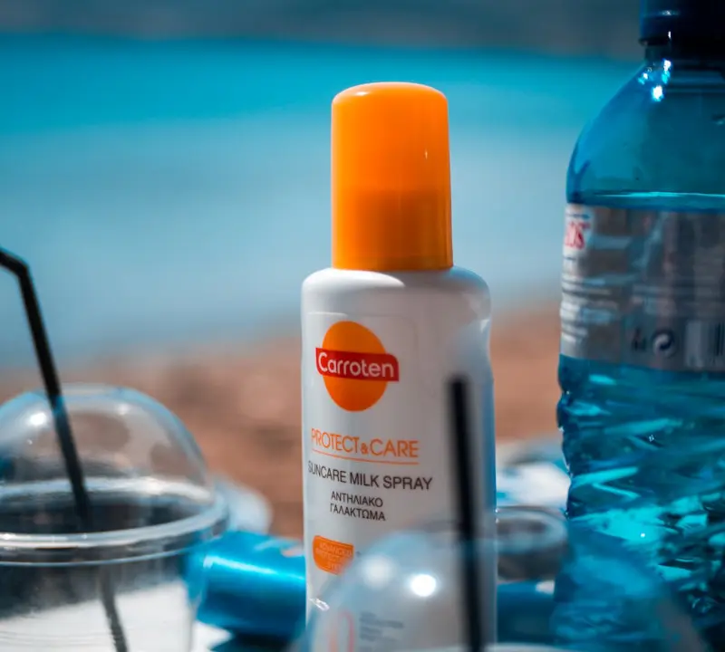 white and orange plastic bottle on blue table